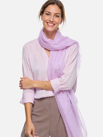 Woman wearing a light purple scarf on a white background