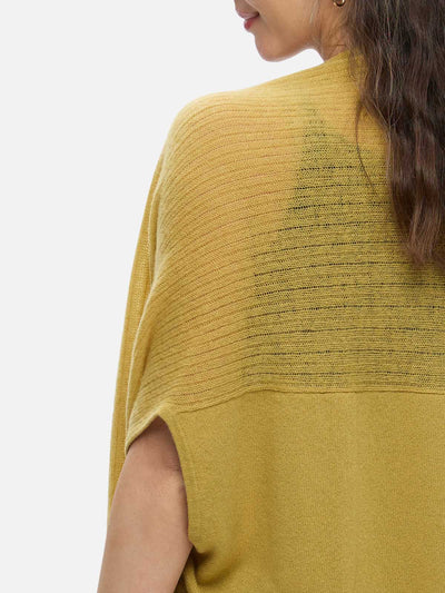 Yellow knit cashmere vest worn by a person on a white background
