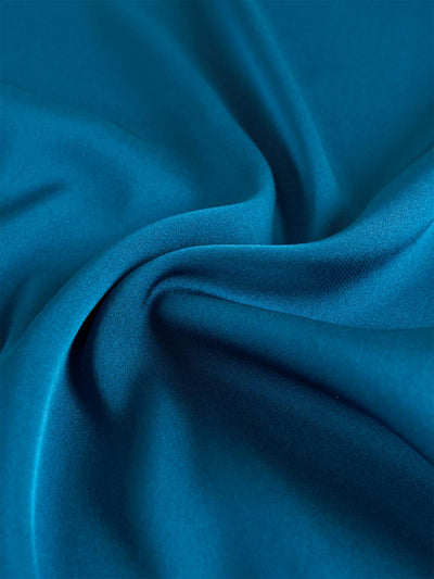 Close-up of blue silk top with folds
