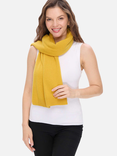 Woman wearing a mustard yellow scarf on a white background