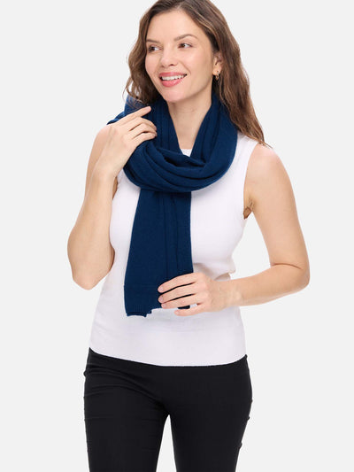 Woman wearing a navy blue scarf on a white background