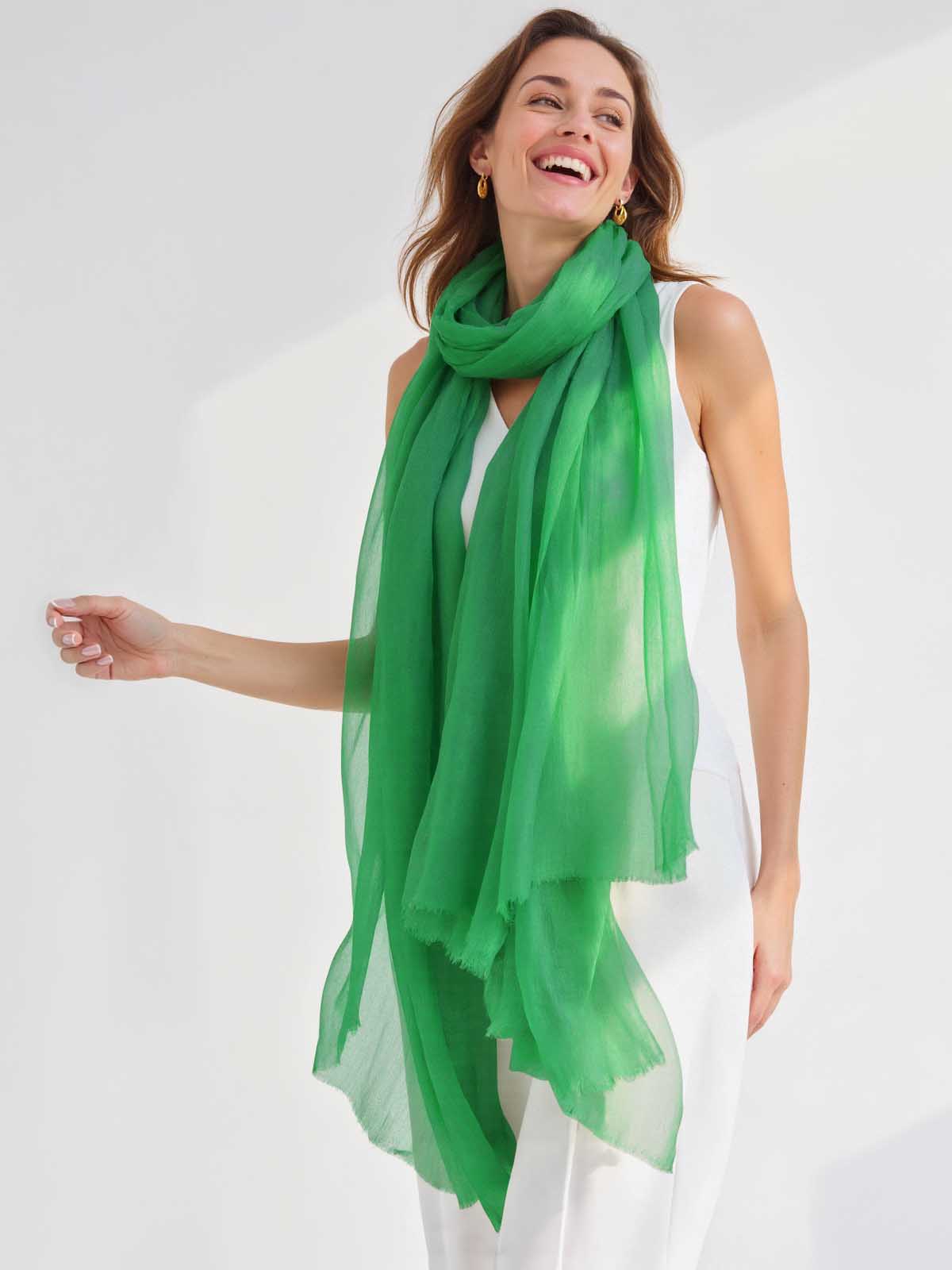 Woman wearing a green scarf on a white background