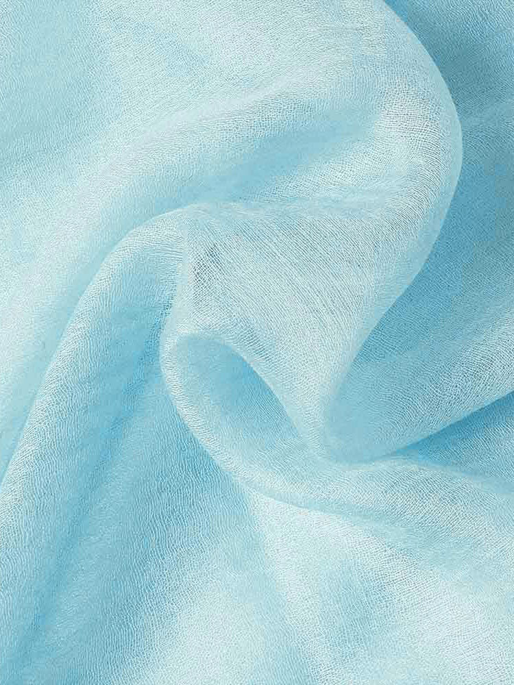 Light blue cashmere fabric with a soft, semi-transparent texture and elegant draped folds.