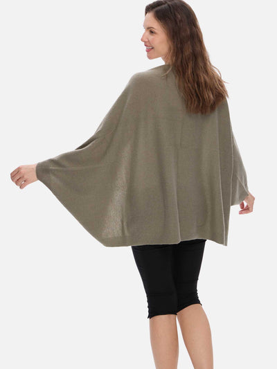 Woman wearing a beige cashmere wrap on a white background