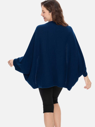 Woman wearing a blue cashmere wrap on a white background