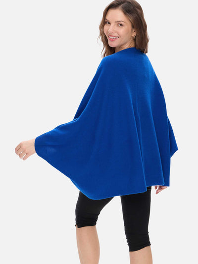 Woman wearing a blue cashmere wrap on a white background