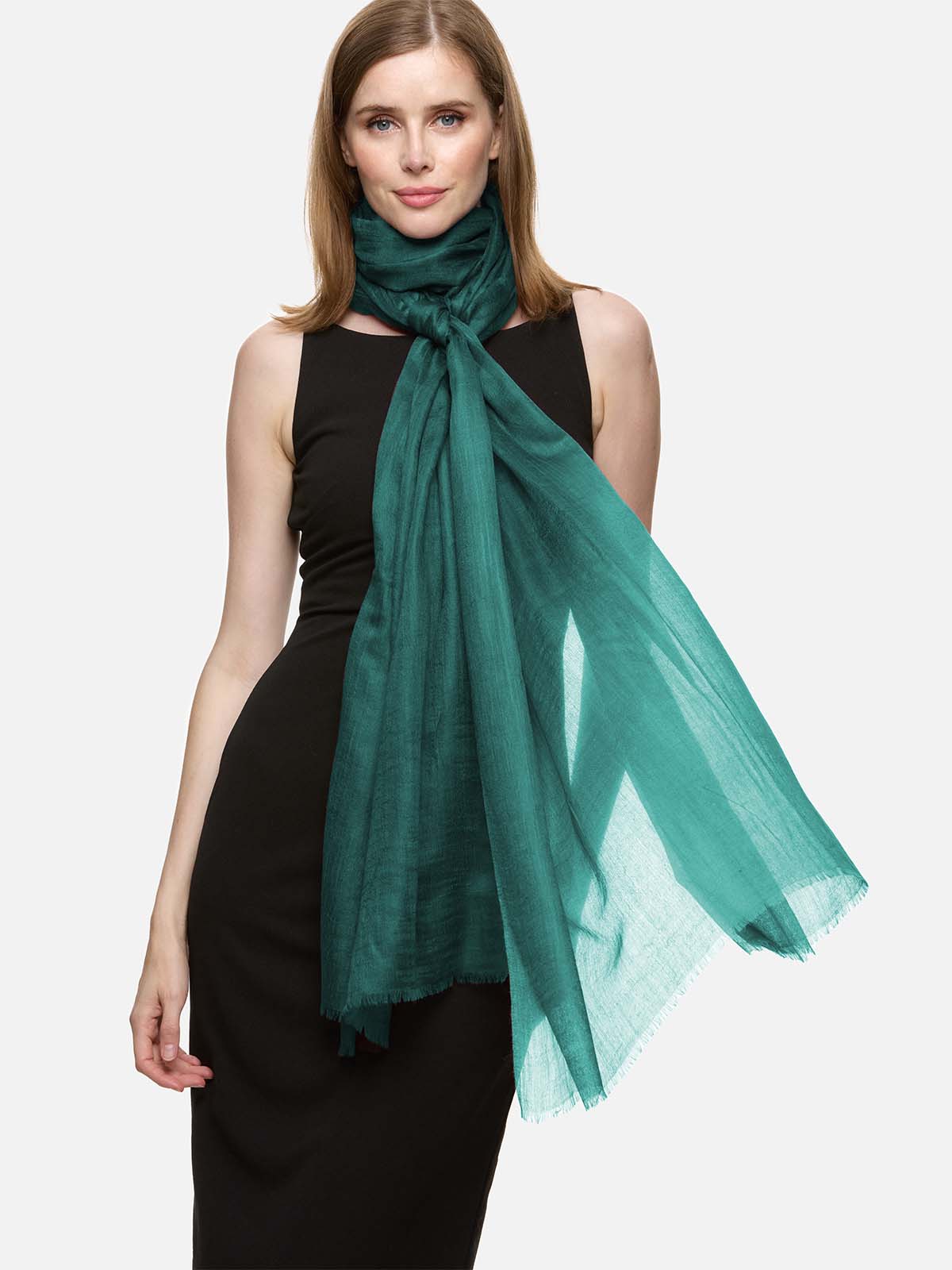 Woman wearing a green scarf around her neck on a white background