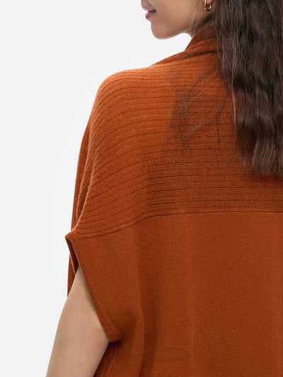 Rust cashmere vest worn by a person on a white background