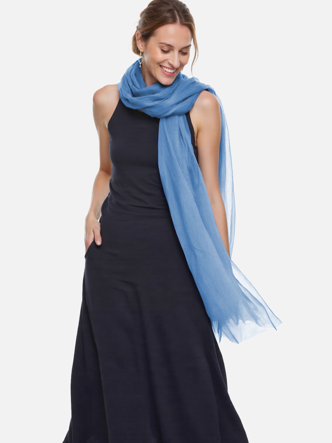 Woman wearing a blue scarf and black dress on a white background