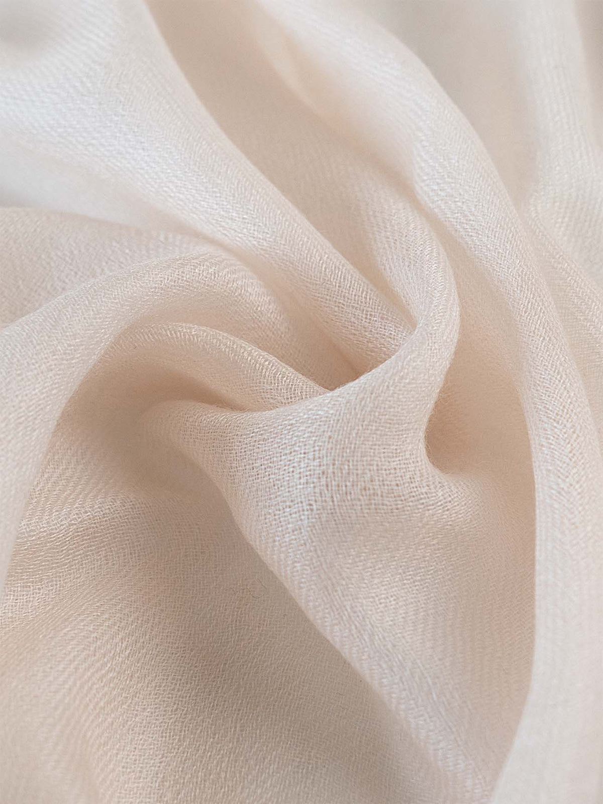 A close-up of the ivory Featherlight Cashmere Scarf.