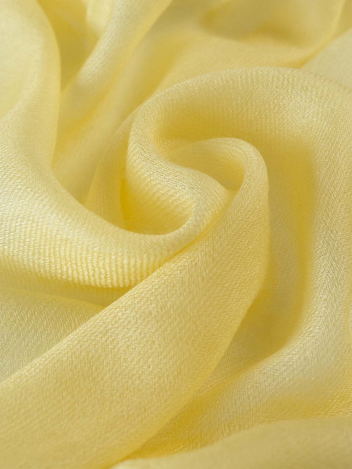 A close-up of the Featherlight Square Yellow Cashmere Scarf.