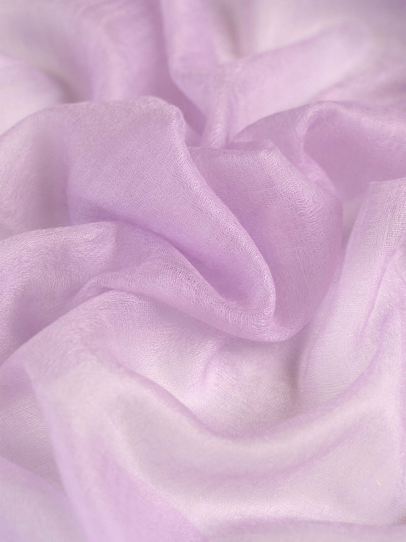 Woman wearing a light purple scarf on a white background