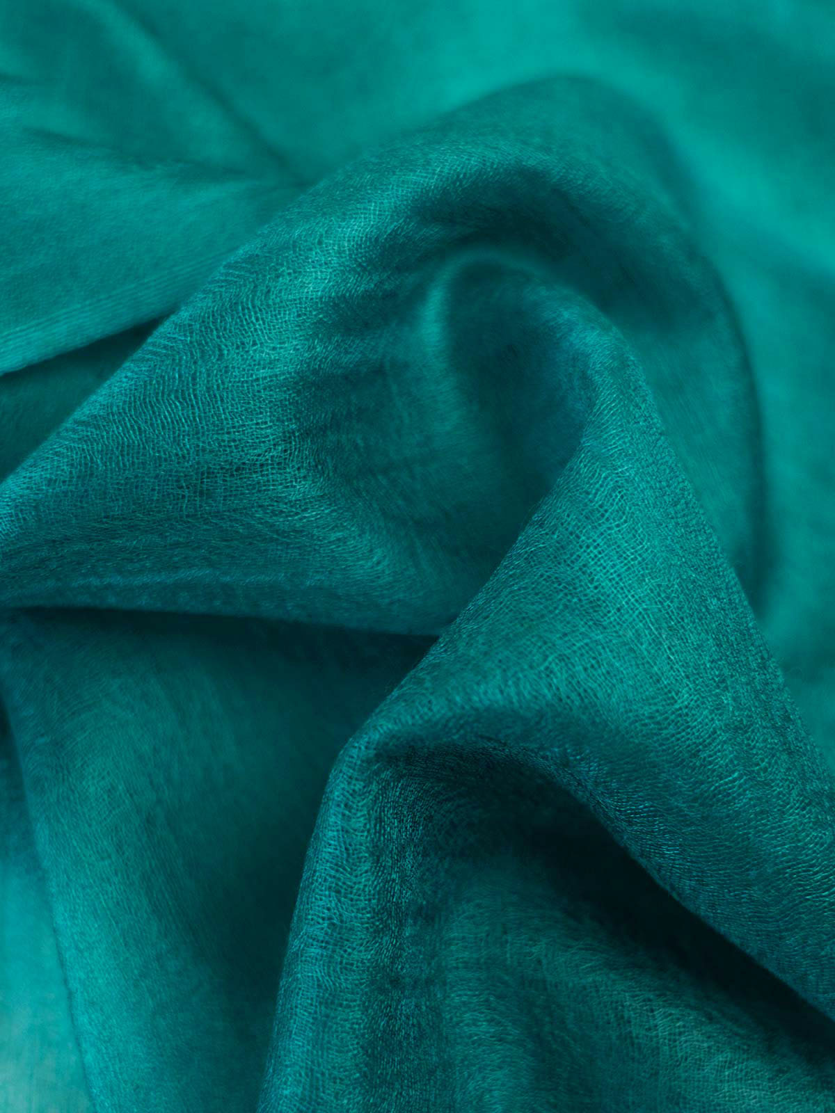 Close-up of teal scarf with folds