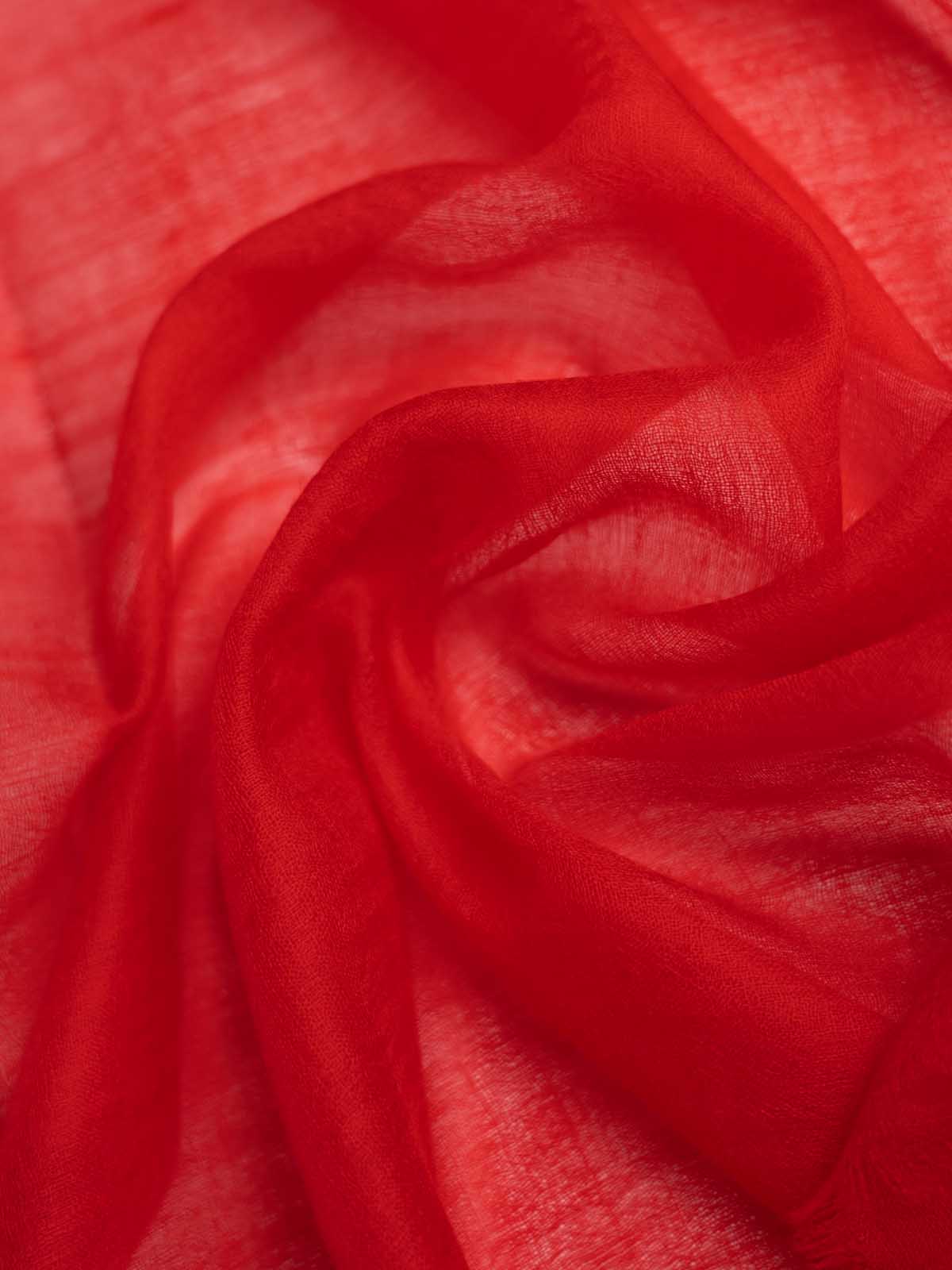 A close-up of the red featherlight cashmere scarf sheer fabric with soft folds and a lightweight texture.