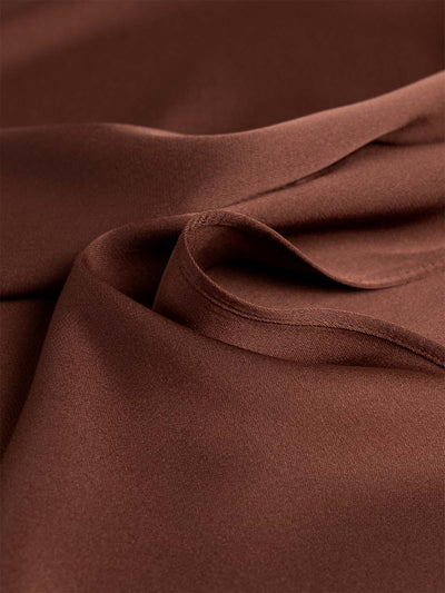 Close-up of brown silk top with folds