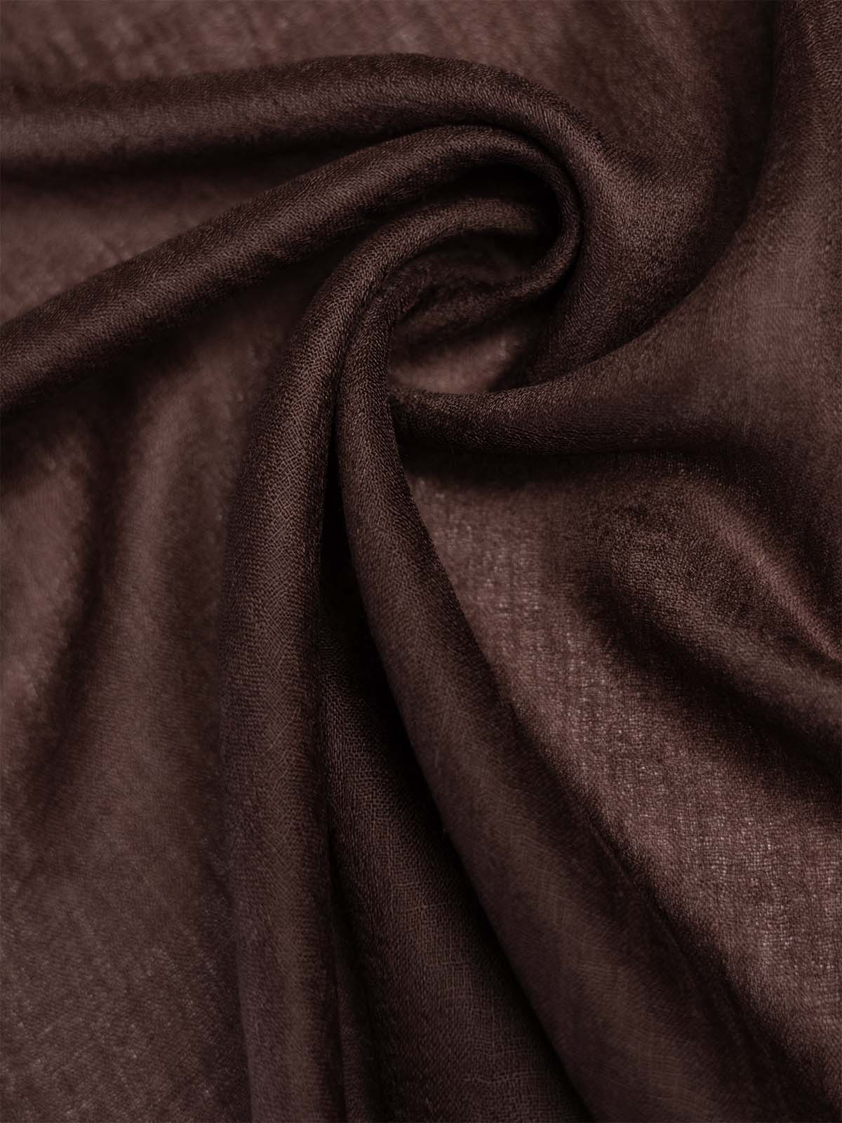 A close-up of draped featherlight brown cashmere scarf with a soft, slightly sheer texture and gentle folds.