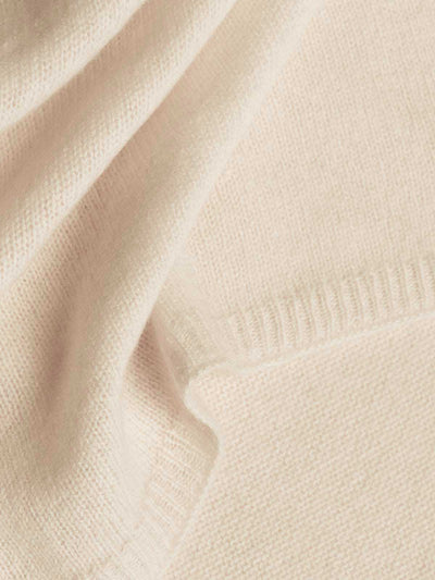 Close-up of beige cashmere wrap with soft texture